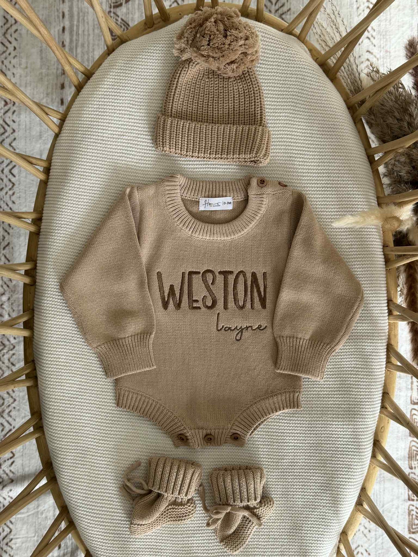 Baby outfit set with romper, hat, and booties