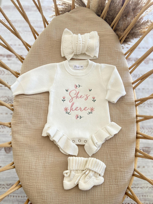 Baby outfit set with 'She's here knit romper hat, and booties.