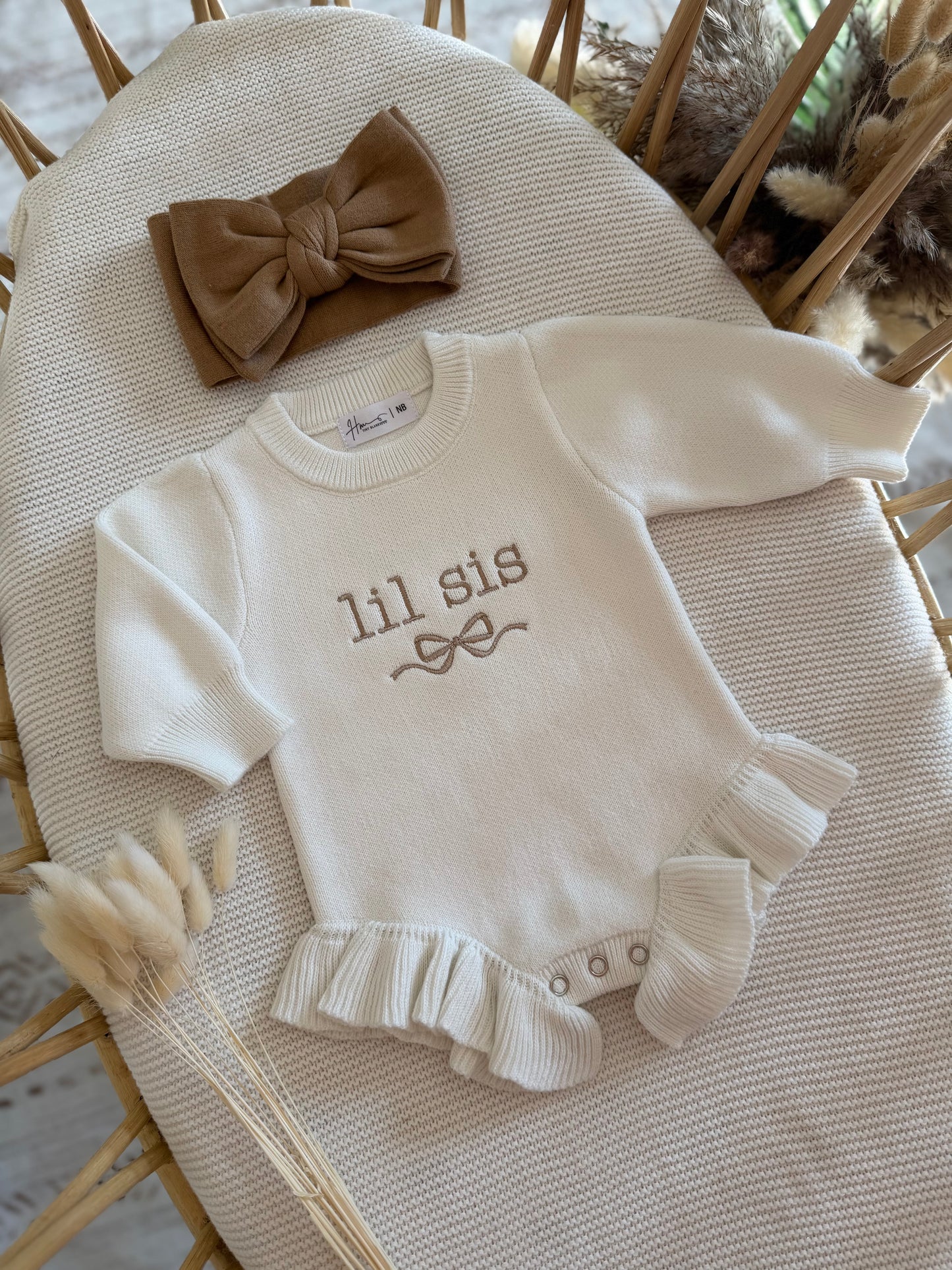 Baby knit romper  with 'lil sis' embroidery